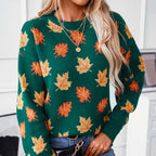 Front view of the Marguerite Sweater Leaf-Print Crew-Neck in green, featuring a crew neckline, long sleeves, orange and yellow autumn leaf print, ribbed cuffs, and a relaxed silhouette. Designed by Bella Hudson.