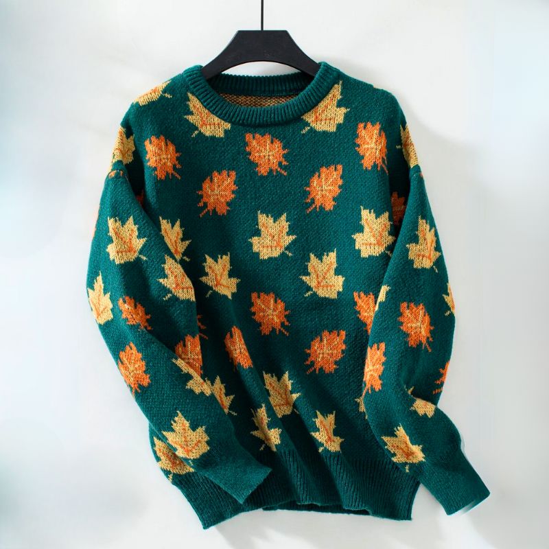 Product view of the Marguerite Sweater Leaf-Print Crew-Neck in green, featuring a crew neckline, long sleeves, orange and yellow autumn leaf print, ribbed cuffs and hem, and a relaxed silhouette. Designed by Bella Hudson.