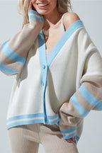 Marielle Blue color block cardigan with light blue V-neck trim and beige and blue striped sleeves, styled over a ribbed tank.