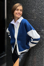 Marielle Dark Blue color block cardigan with white striped sleeves, worn over a white collared shirt and a black skirt.