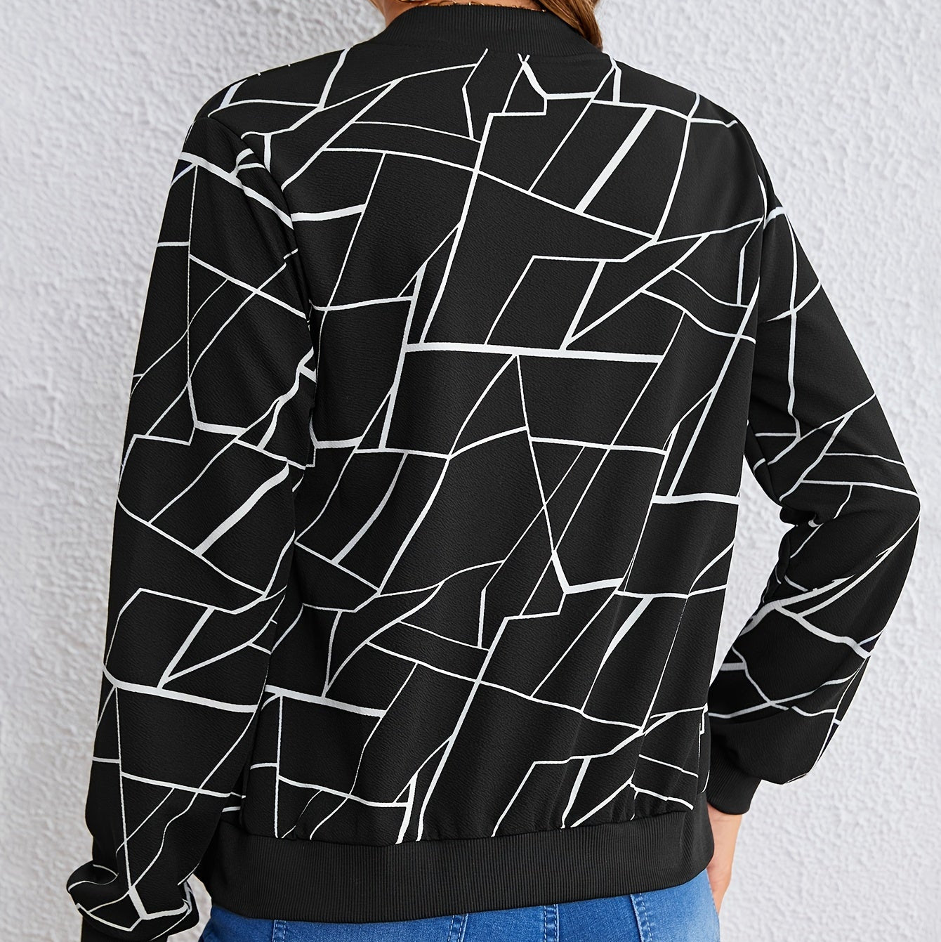 Back view of the Marisol Jacket Bomber Geometric-Print in black, featuring the all-over white geometric line print, long sleeves, and classic bomber silhouette. Designed by Bella Hudson.