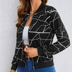 Lifestyle view of the Marisol Jacket Bomber Geometric-Print in black, featuring the bold geometric pattern, zip-front design, long sleeves, and casual bomber styling. Designed by Bella Hudson.