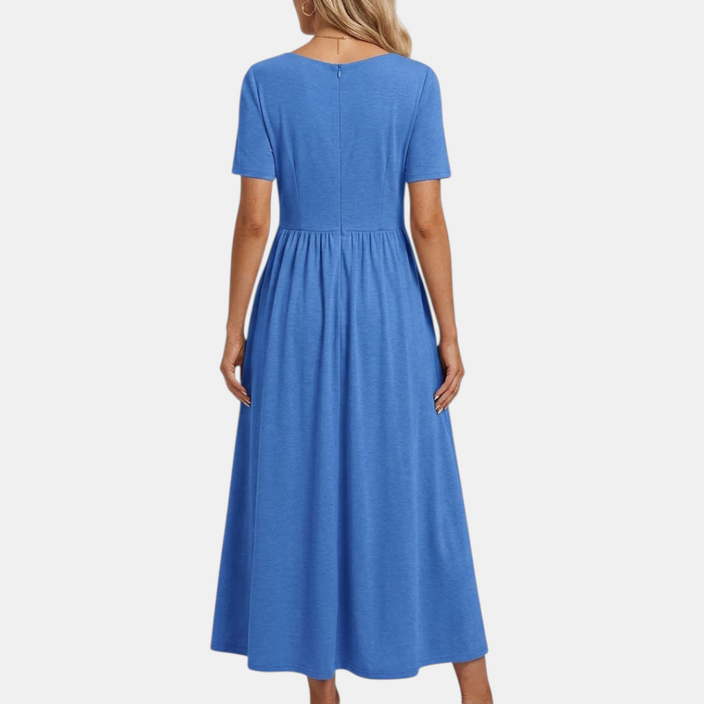 Back view of the Marisol Summer Midi Dress Ruched V-Neck in blue, highlighting the relaxed fit, gathered waist, flowing skirt, and elegant midi-length silhouette. Designed by Bella Hudson.