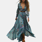 Flowing view of the Marlena Maxi Dress Floral-Embroidered Long-Sleeve Boho in blue, showcasing the embroidered floral design, long sleeves, braided waist belt, and elegant maxi silhouette in motion. Designed by Bella Hudson.