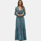 Front view of the Marlena Maxi Dress Floral-Embroidered Long-Sleeve Boho in blue, showcasing the bohemian floral print, braided waist belt, long sleeves, and elegant full-length silhouette. Designed by Bella Hudson.