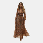 Front view of the Marlena Maxi Dress Floral-Embroidered Long-Sleeve Boho in dark brown, featuring a deep V-neckline, braided waist belt, long sleeves, and vintage-inspired bohemian styling. Designed by Bella Hudson.