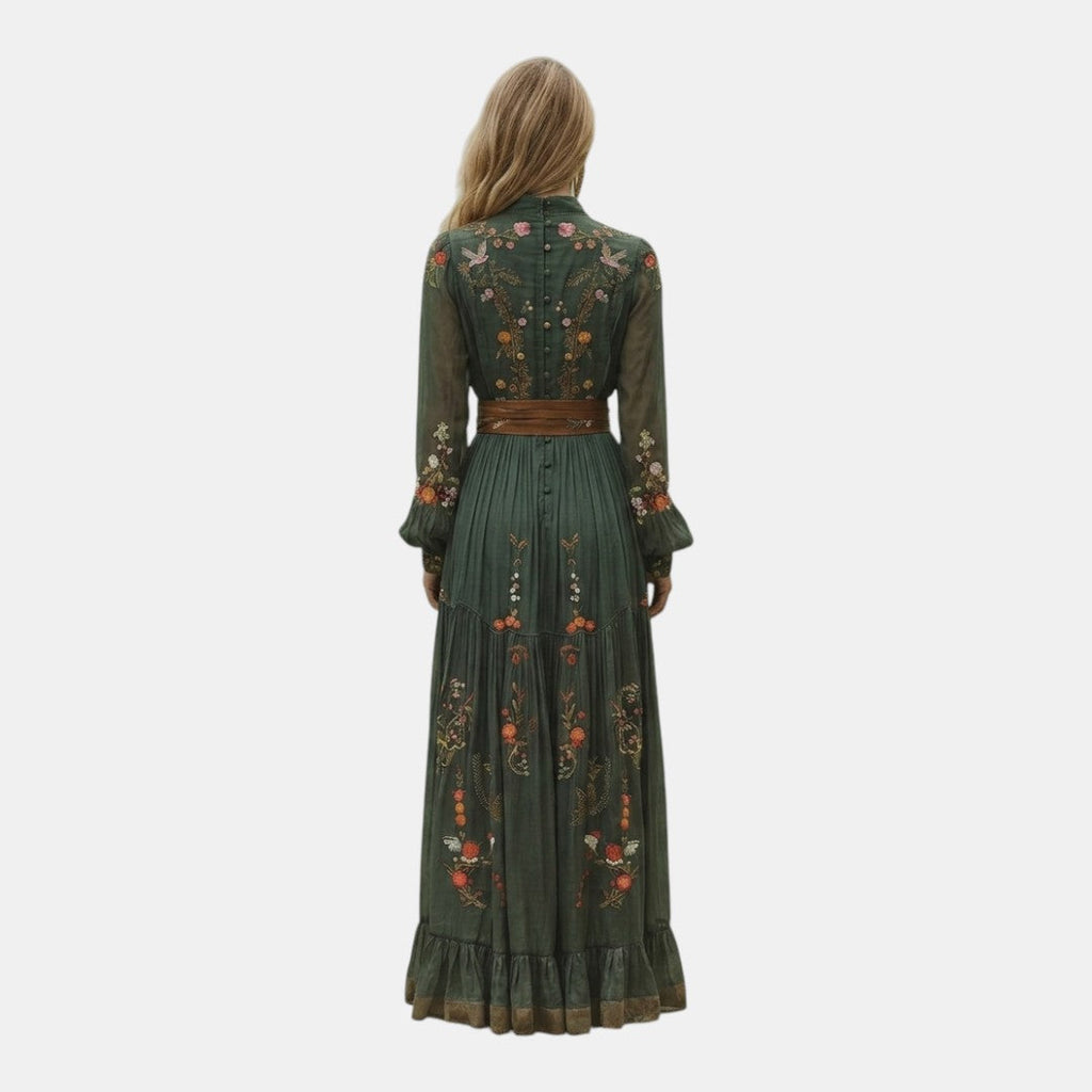 Back view of the Marlena Maxi Dress Floral-Embroidered Long-Sleeve Boho in green, highlighting the relaxed bohemian silhouette, long sleeves, and flowing full-length skirt. Designed by Bella Hudson.