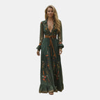 Front view of the Marlena Maxi Dress Floral-Embroidered Long-Sleeve Boho in green, featuring a deep V-neckline, long sleeves, embroidered floral details, a braided waist belt, and a flowing bohemian maxi silhouette. Designed by Bella Hudson.