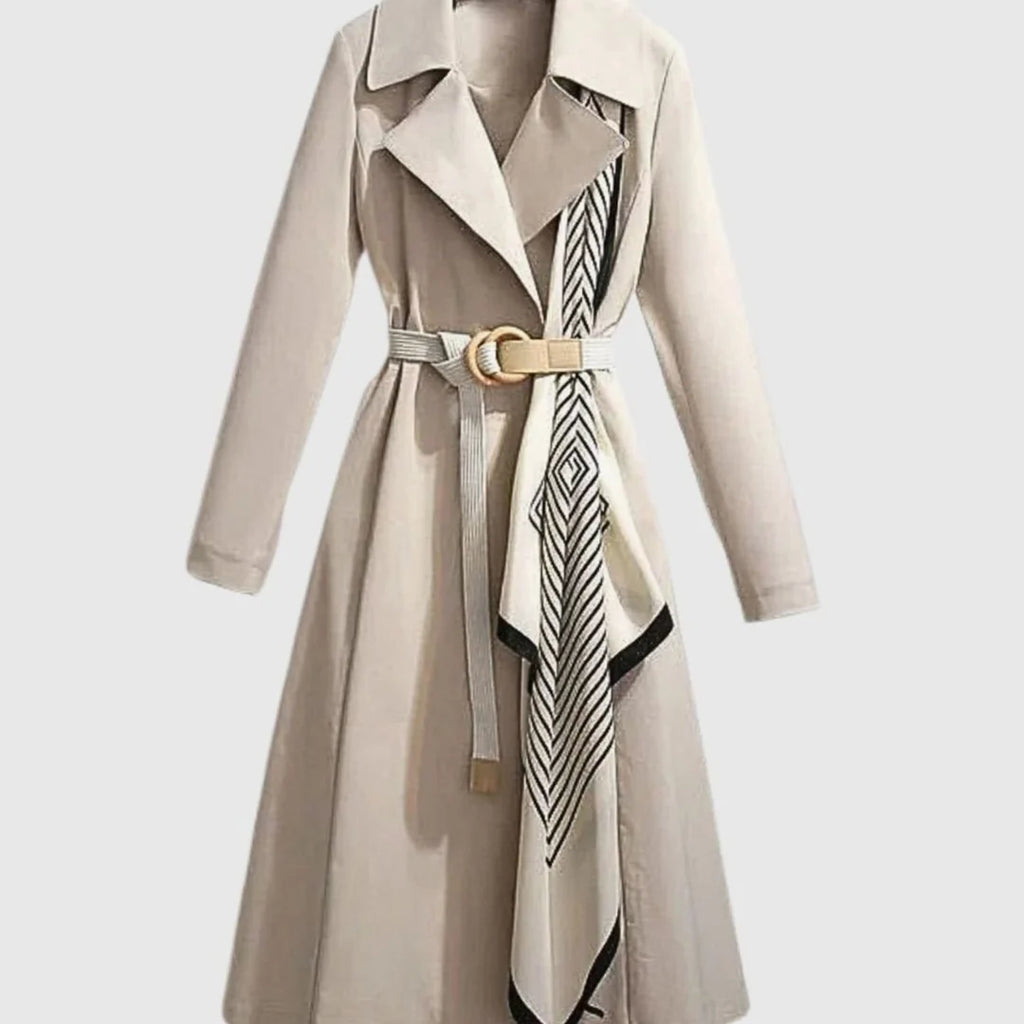 Maya Beige midi trench coat with wide notched lapel collar, adjustable buckle belt, patterned scarf detail, and long sleeves