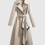Maya Beige midi trench coat with wide notched lapel collar, adjustable buckle belt, patterned scarf detail, and long sleeves