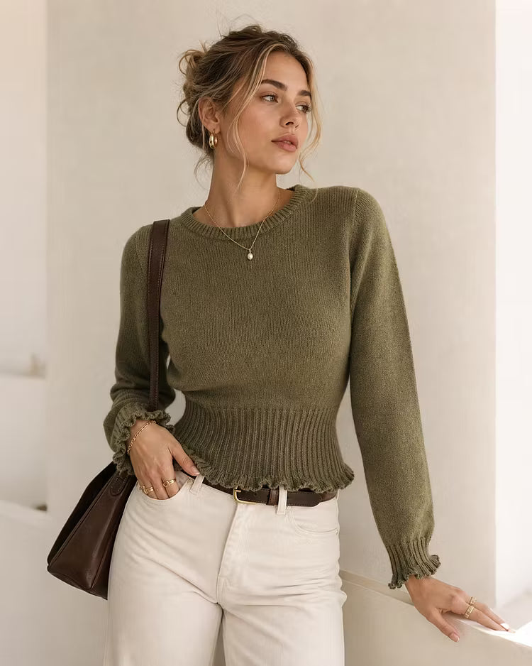 Maya Green ribbed knit sweater with ribbed cuffs and peplum-style hem, worn with white jeans and a brown leather bag.