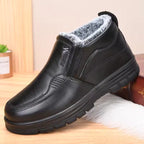 Mia Black plush-lined ankle boots with elastic gussets and thick textured outsole, shown from the side