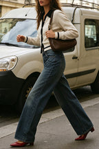 Mia Off White knit cardigan in a full-body street style look with wide-leg jeans, red pointed heels, and a brown shoulder bag.