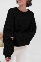 Mila Black cable-knit crewneck sweater shown from the front with ribbed neckline and cuffs.