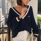 Mila Dark Blue knit sweater with deep V-neckline, dropped shoulders, and contrast-trimmed cuffs