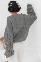 Mila Gray cable-knit sweater shown from the back with vertical ribbing and cable sleeves.