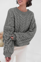 Mila Gray cable-knit crewneck sweater shown from the front with chunky cable detail.