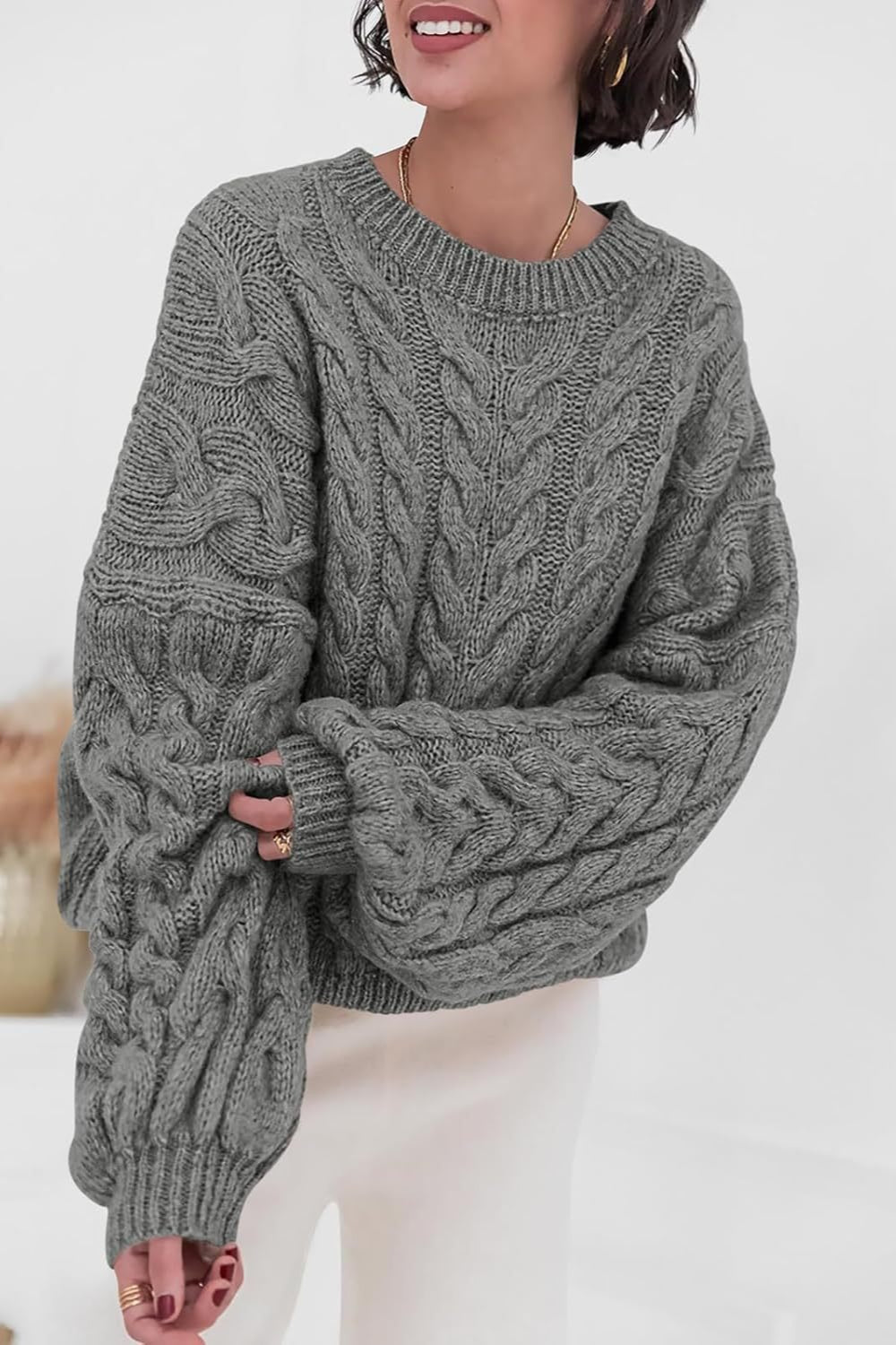 Mila Gray cable-knit crewneck sweater shown from the front with chunky cable detail.