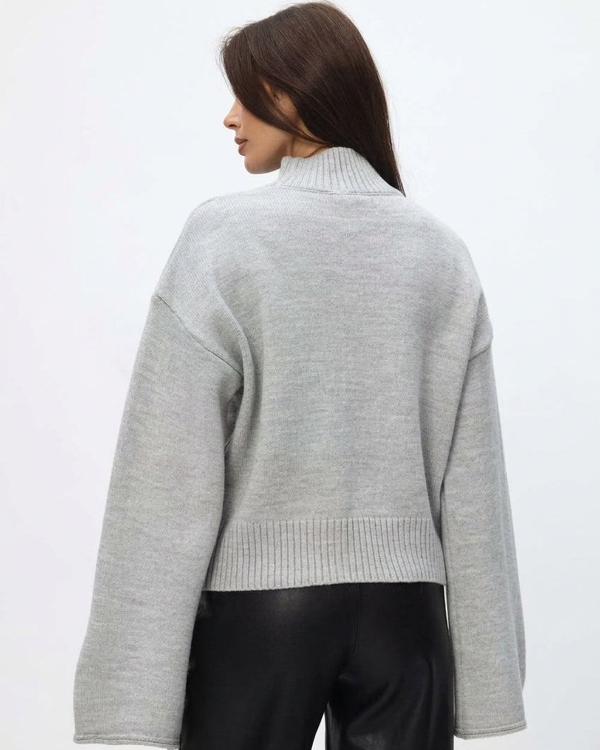 Mila Gray mock-neck sweater from the back, showing the funnel neck, dropped shoulders and ribbed hem.