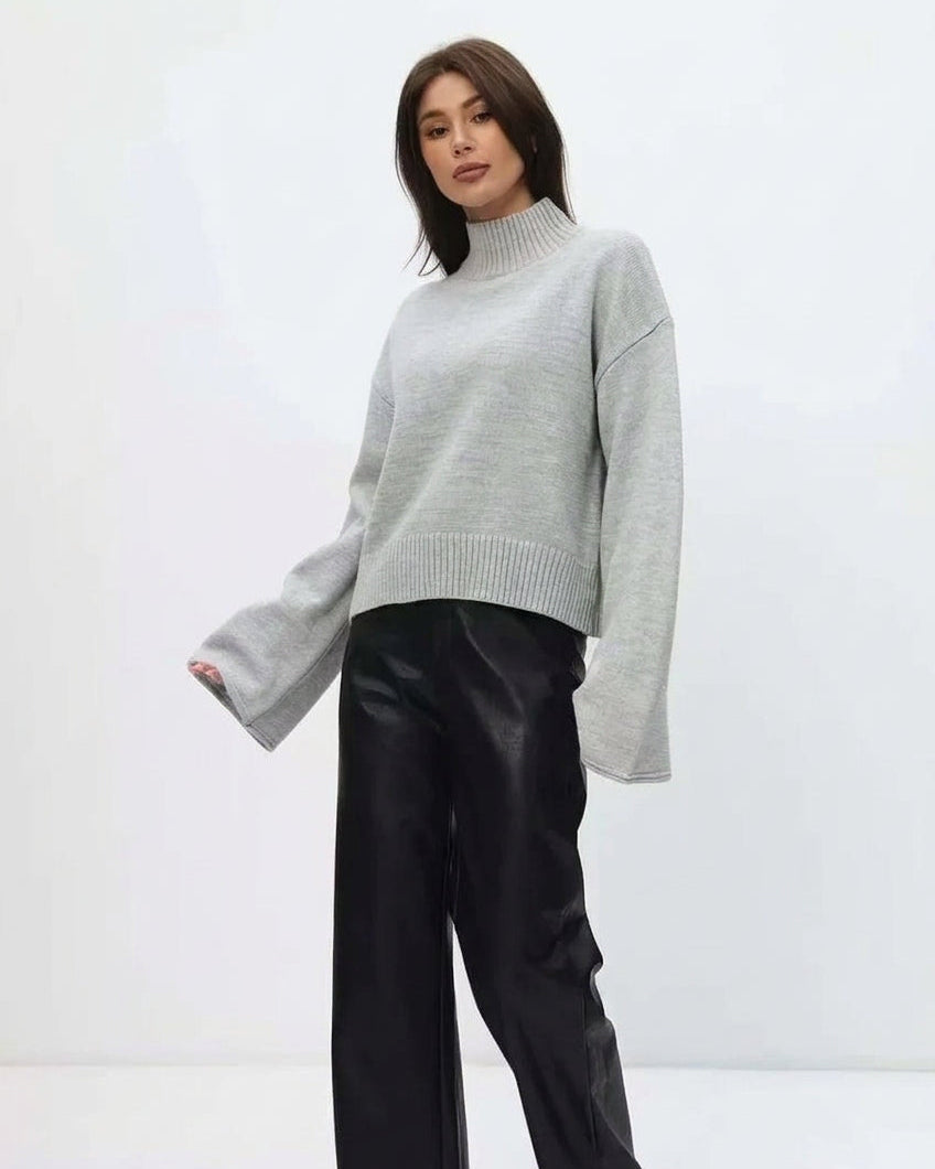 Mila Gray mock-neck sweater styled with black wide-leg pants in a three-quarter pose.