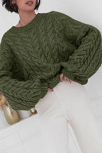 Mila Green cable-knit crewneck sweater shown close up with chunky cable texture.