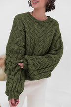 Mila Green cable-knit crewneck sweater shown from the front with ribbed cuffs and neckline.