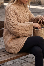 Mila Khaki cable-knit sweater side view showing the chunky cable texture on the sleeve and ribbed hem.