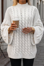 Mila White sweater front view showing the cable-knit texture, ribbed mock neck and flared sleeves with ribbed cuffs.