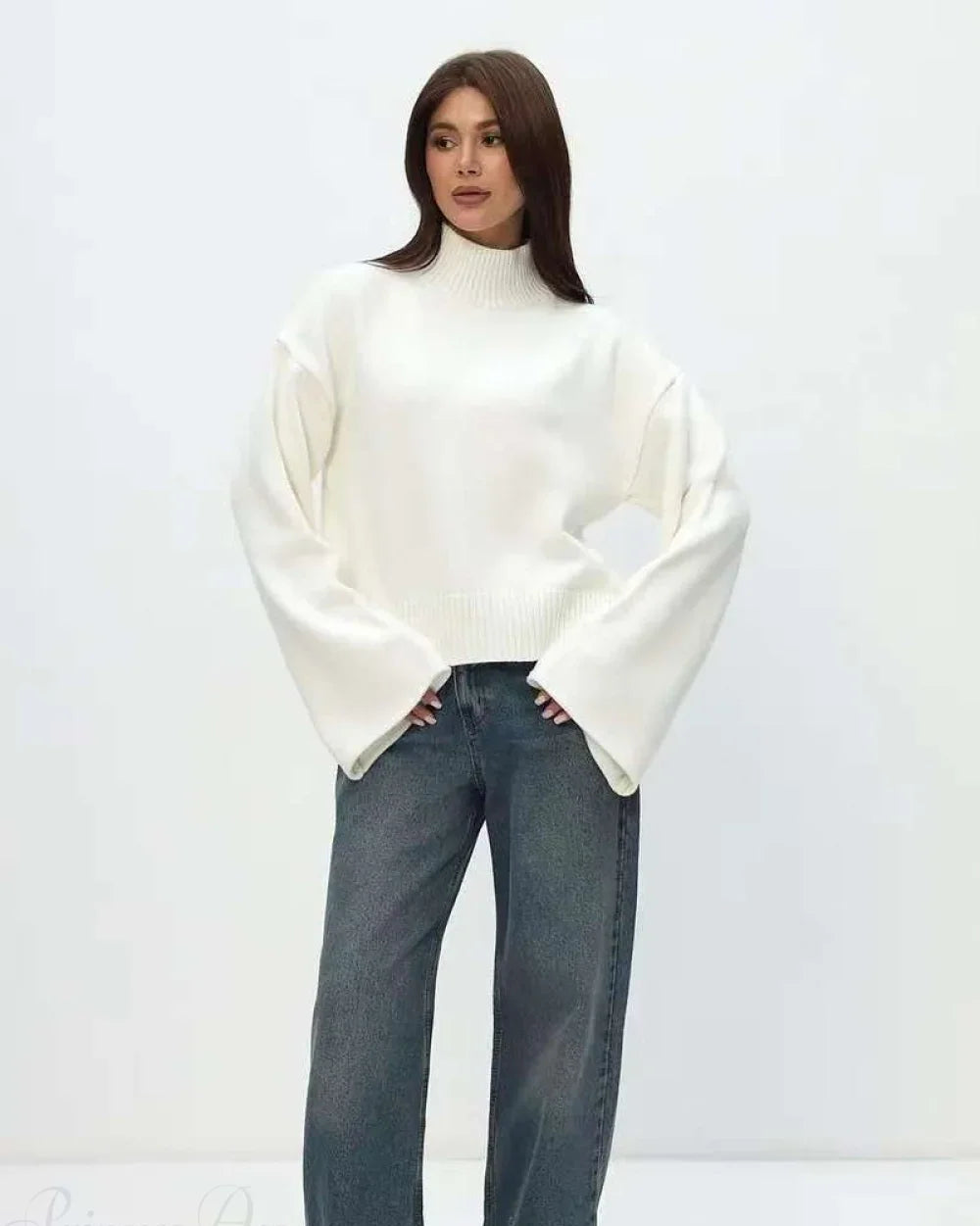 Mila White mock-neck sweater styled with wide-leg jeans in a full-length view.