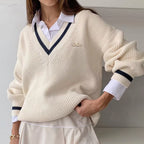 Mila White V-neck knit sweater with contrast trim and relaxed silhouette, layered over a collared shirt