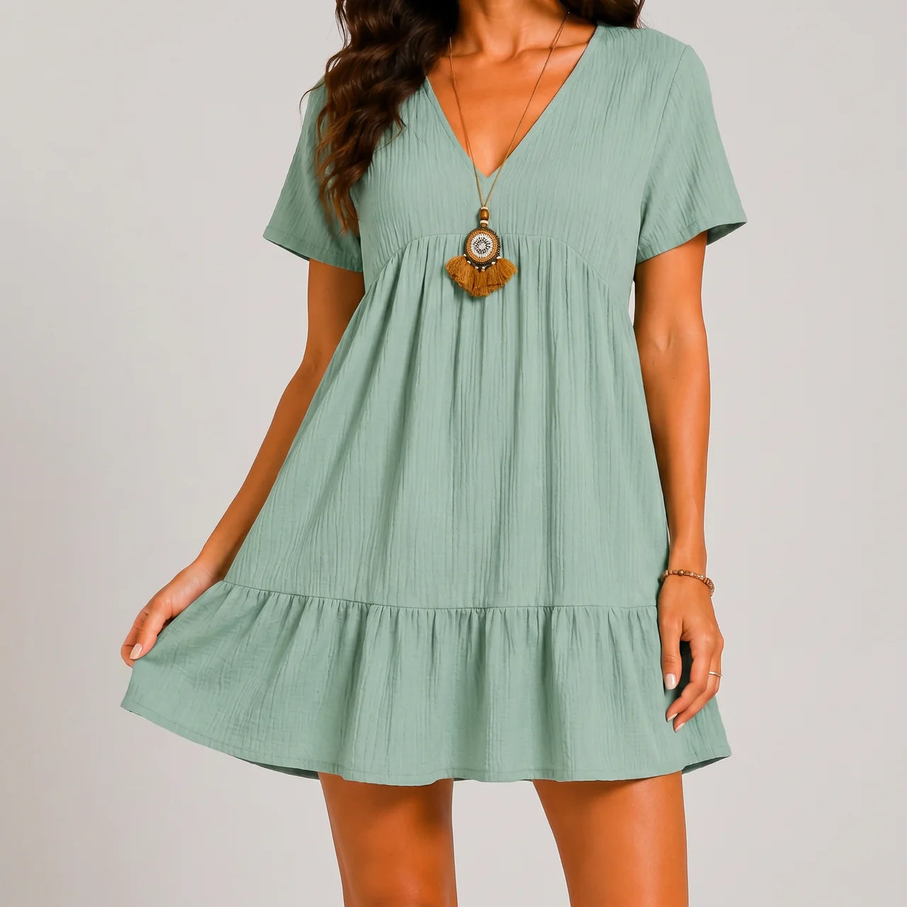 Front view of mint green tiered mini dress with short sleeves by BELLA HUDSON
