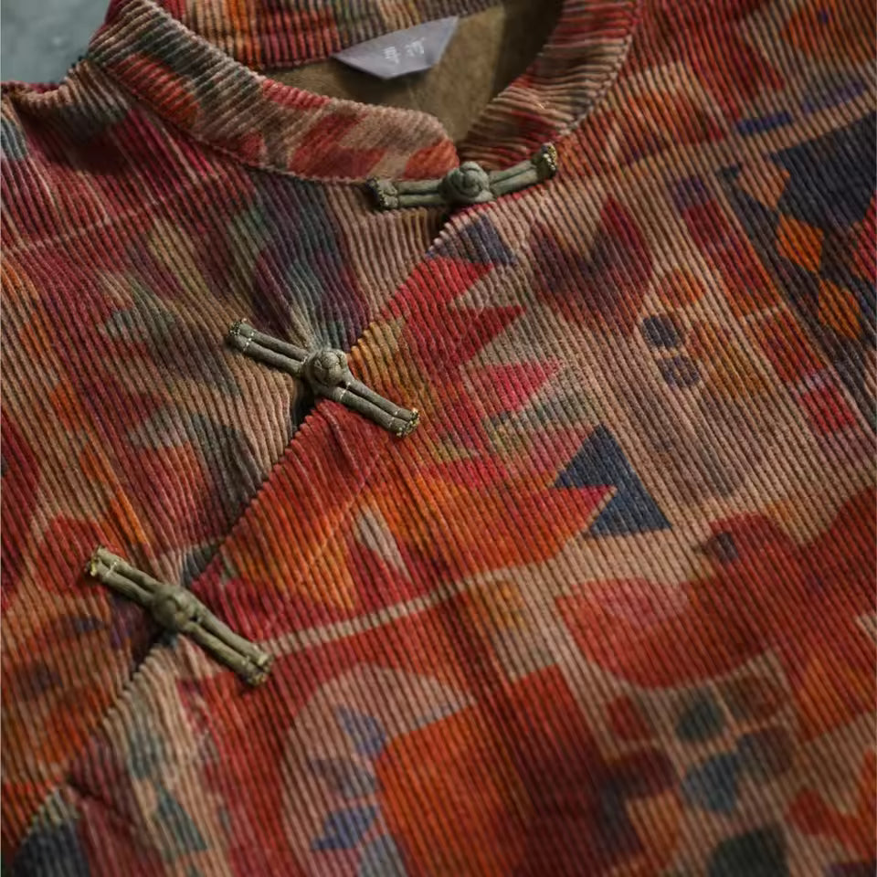 Mira Bronze corduroy midi dress close-up showing floral print and frog-button details