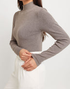 Mirelle Gray sweater close-up showing the ribbed mock neck, fitted body, and long sleeve cuff.