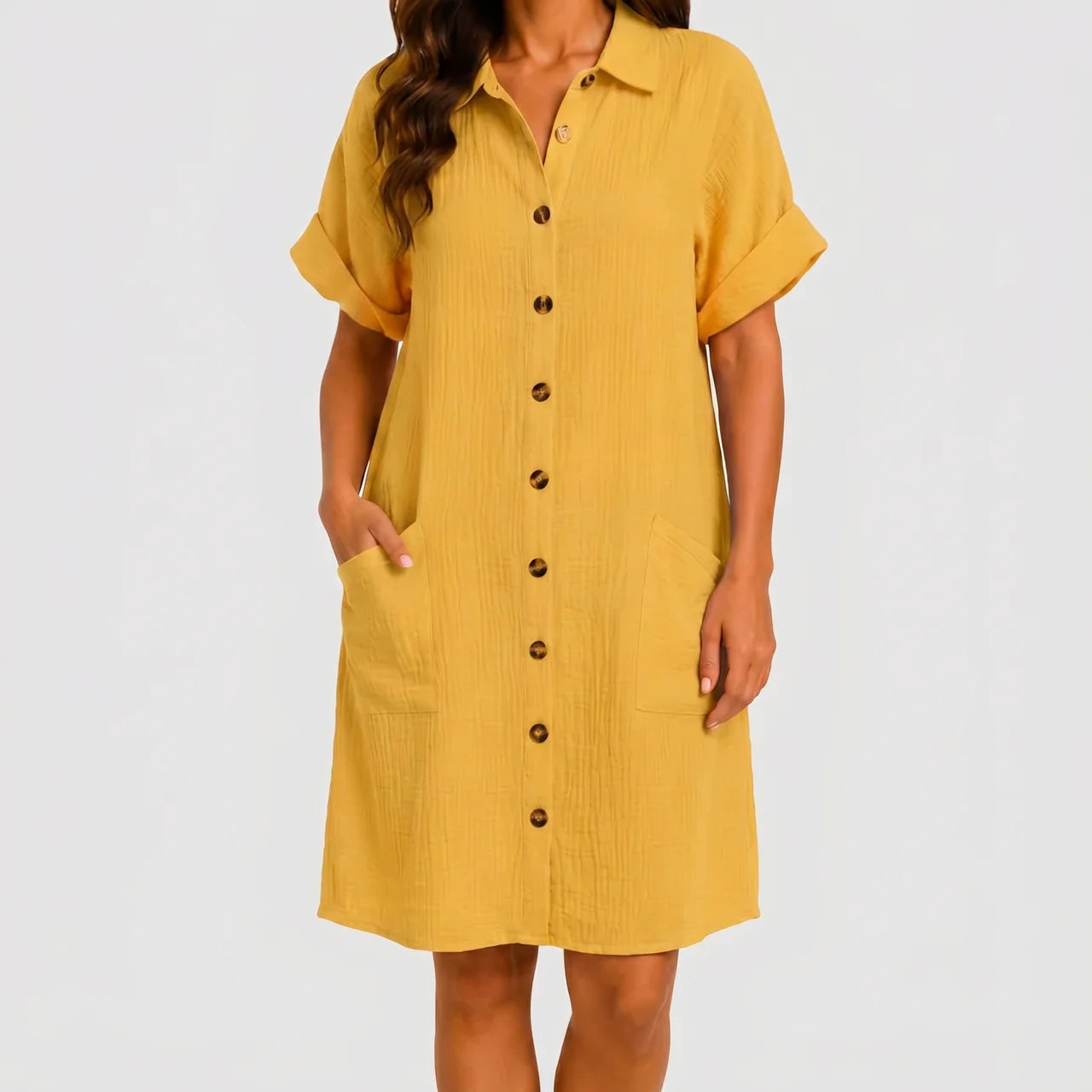 Front view of mustard yellow button front midi dress with short sleeves and side pockets by BELLA HUDSON