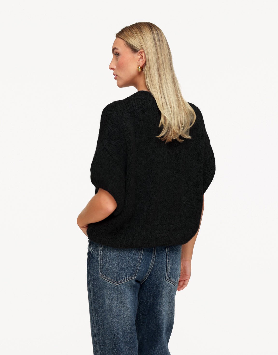 Nadine Black high neck knit sweater shown from the back with dropped shoulders and a rounded hem.