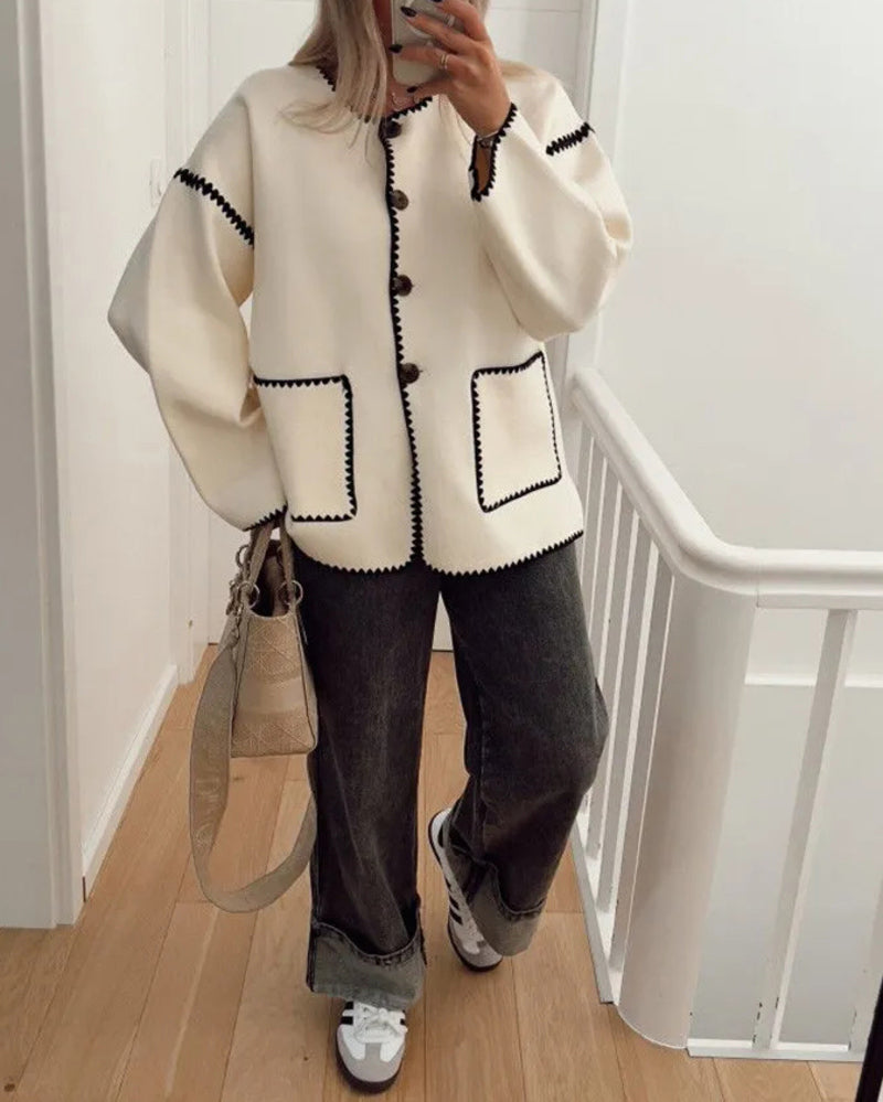 Nadorine White button-front jacket worn full-length with wide-leg jeans and sneakers.