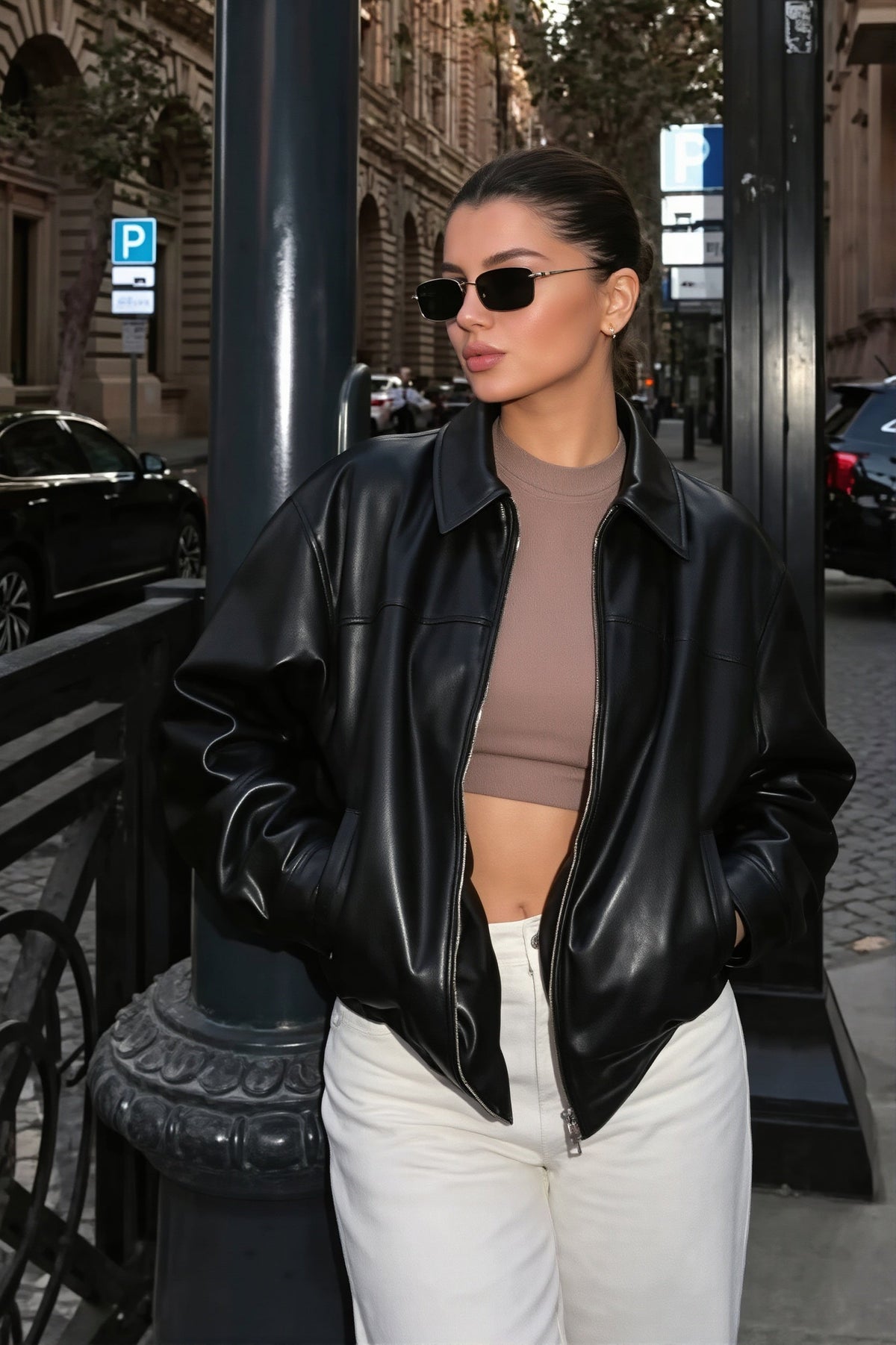 Naomi Black faux leather bomber jacket featuring a relaxed bomber silhouette, spread collar, long sleeves, and zip-front closure