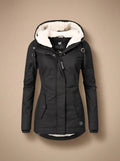 Naomi Black hooded long parka jacket featuring a plush-lined hood, fitted waist, full front closure, long sleeves, and front pockets