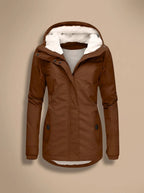 Naomi Brown long parka jacket with a plush-lined hood, shaped waist, long sleeves, front closure, and practical pockets