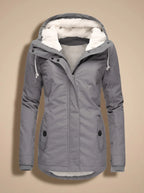 Naomi Gray hooded long parka jacket featuring a plush-lined hood, fitted waist, front closure, long sleeves, and practical pockets