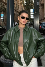 Naomi Green faux leather bomber jacket shown with a roomy silhouette, dropped shoulders, spread collar, and full zip front