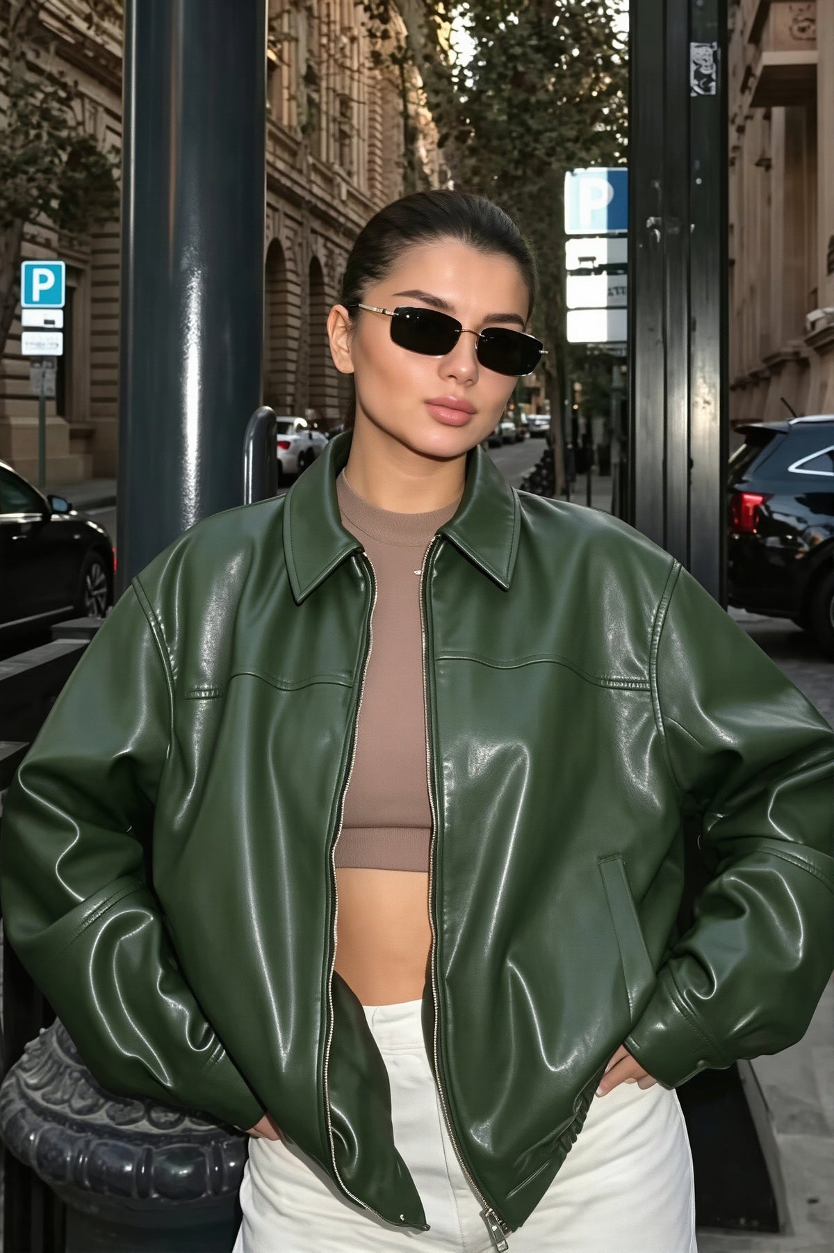 Naomi Green faux leather bomber jacket shown with a roomy silhouette, dropped shoulders, spread collar, and full zip front