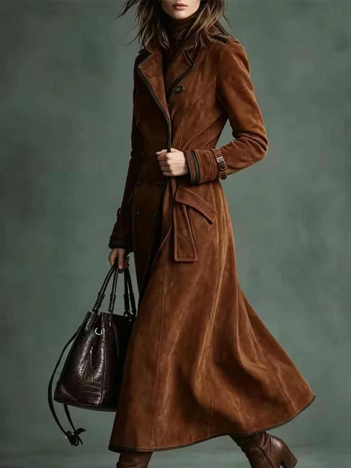 Natalie Brown double-breasted trench coat with adjustable tie belt and long flared hem, styled with boots and a handbag