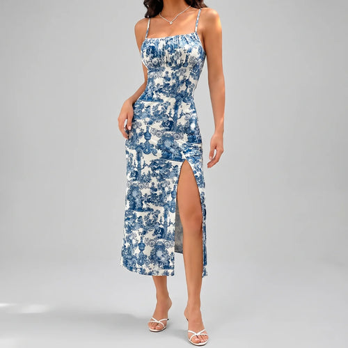 Front view of navy blue floral slit maxi dress with spaghetti straps and fitted silhouette by BELLA HUDSON