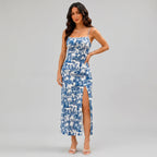 Side view of navy blue floral slit maxi dress with spaghetti straps and fitted silhouette by BELLA HUDSON