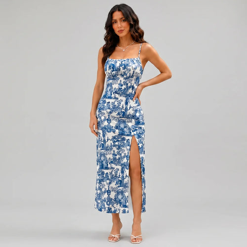 Side view of navy blue floral slit maxi dress with spaghetti straps and fitted silhouette by BELLA HUDSON