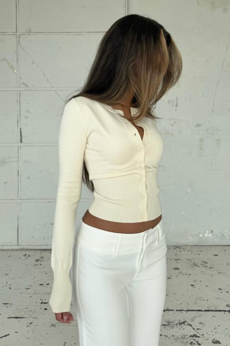 Nina Beige knit cardigan from the side showing the long sleeve and ribbed cuff.