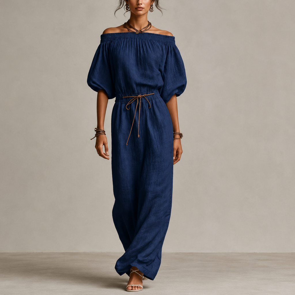 Noa Off-Shoulder Lightweight Linen Maxi Dress in dark blue featuring an off-shoulder neckline, lantern sleeves, adjustable waist tie, and flowing maxi-length silhouette. Designed by Bella Hudson.