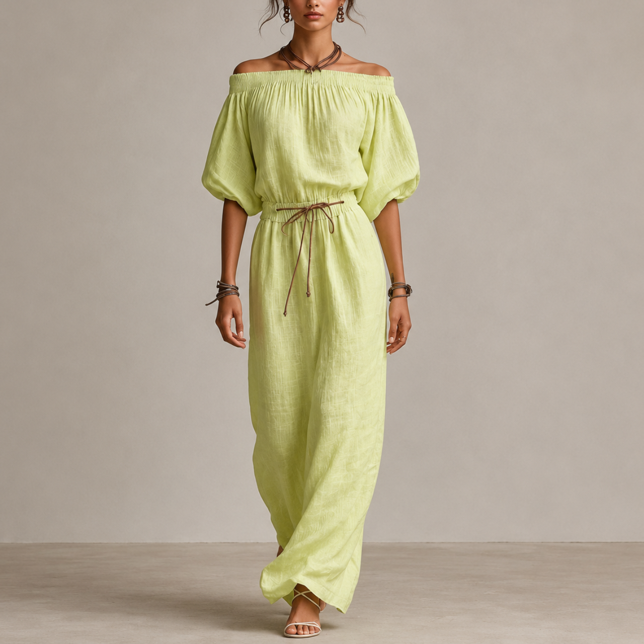 Noa Off-Shoulder Lightweight Linen Maxi Dress in light green featuring an off-shoulder neckline, lantern sleeves, adjustable waist tie, and flowing maxi-length silhouette. Designed by Bella Hudson.
