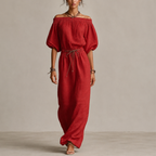 Noa Off-Shoulder Lightweight Linen Maxi Dress in red featuring an off-shoulder neckline, lantern sleeves, adjustable waist tie, and flowing maxi-length silhouette. Designed by Bella Hudson.